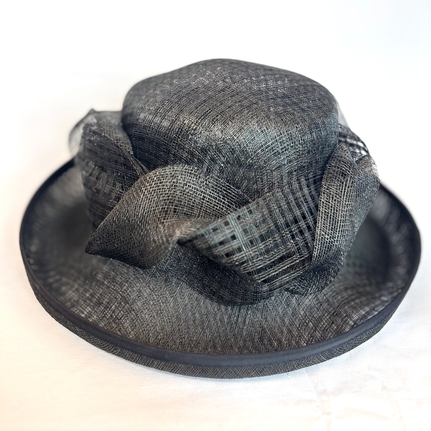 Black structured occasion hat with sculpted flower design