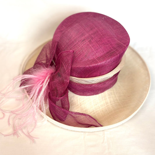 Maroon and cream layered occasion hat with pink feather detail