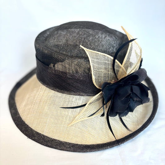 Black and cream occasion hat with feature flower and feather design