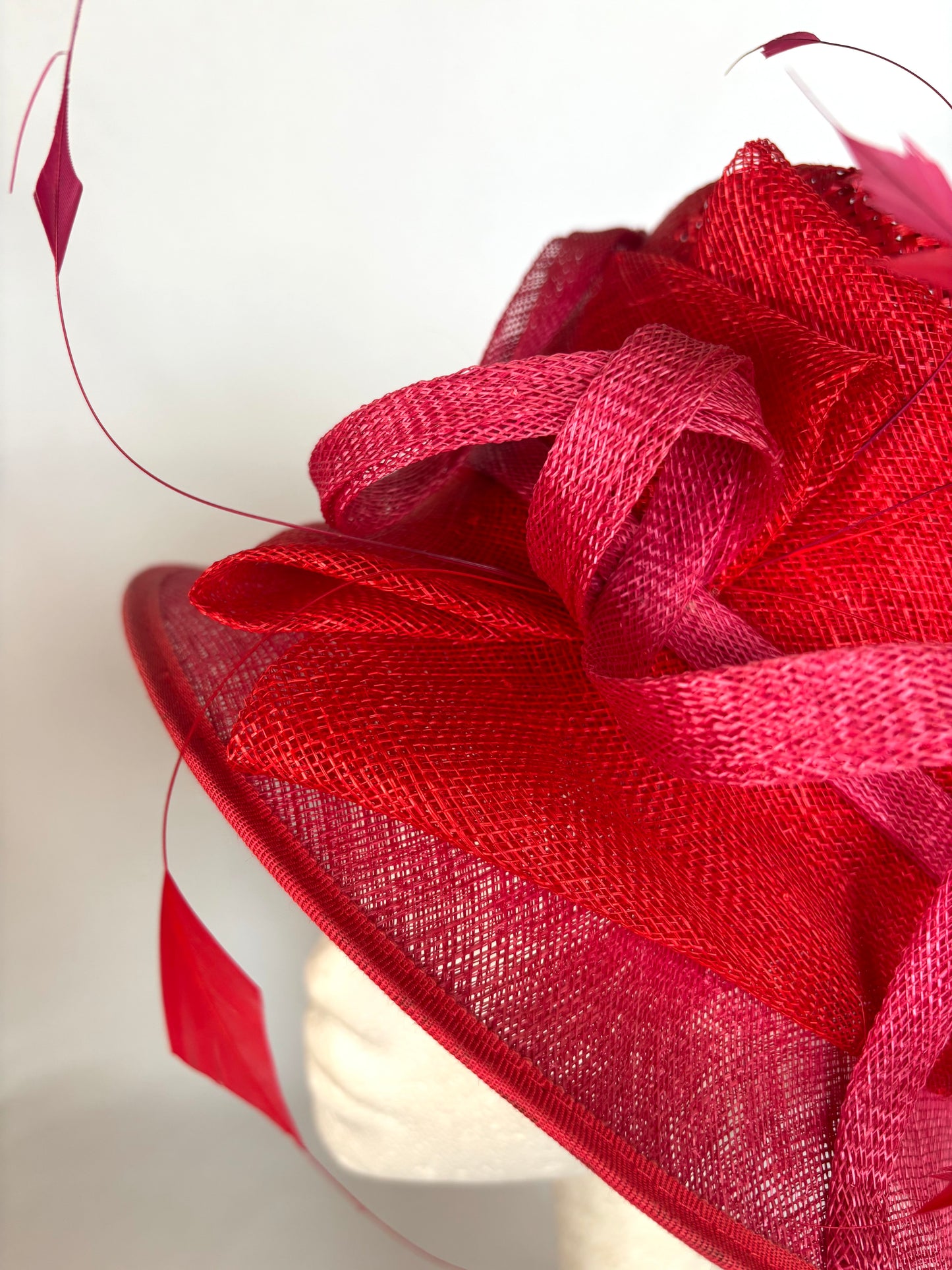 Red structured occasion hat with flower detail