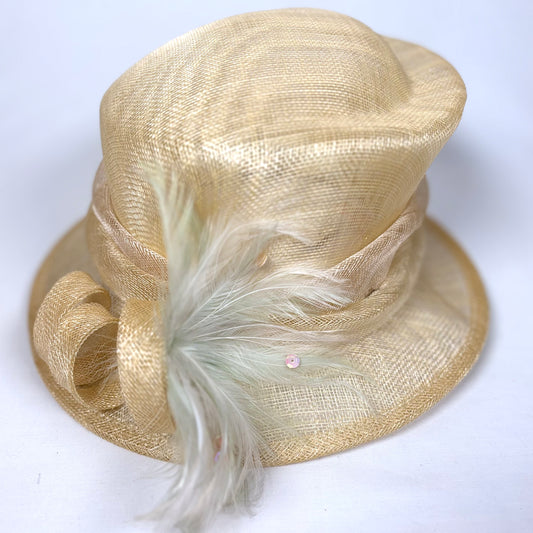Beige straw occasion hat with layered design and green feather detail