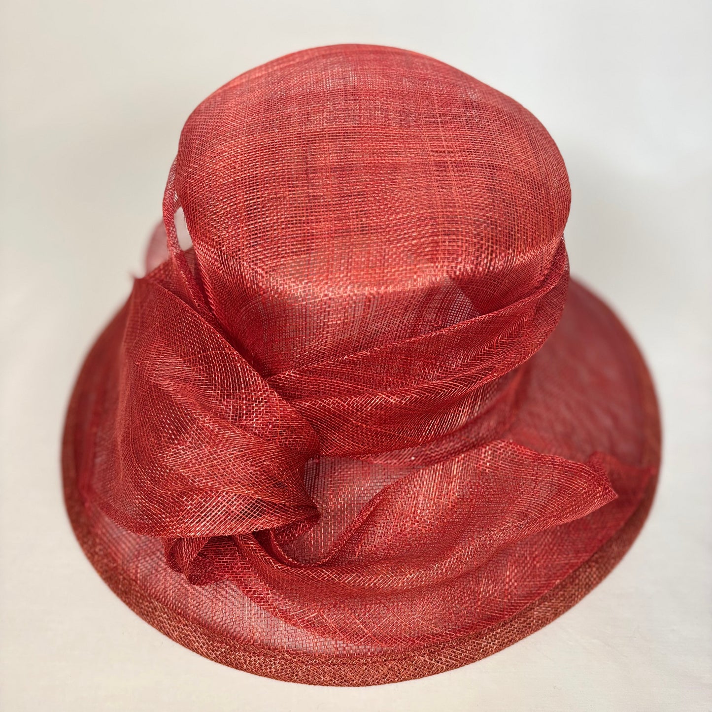 Warm orange occasion hat with structured bow design