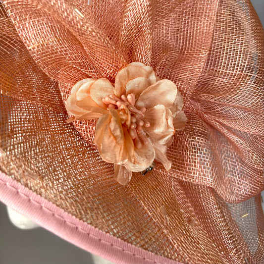 Orange statement occasion hat with bold flower design
