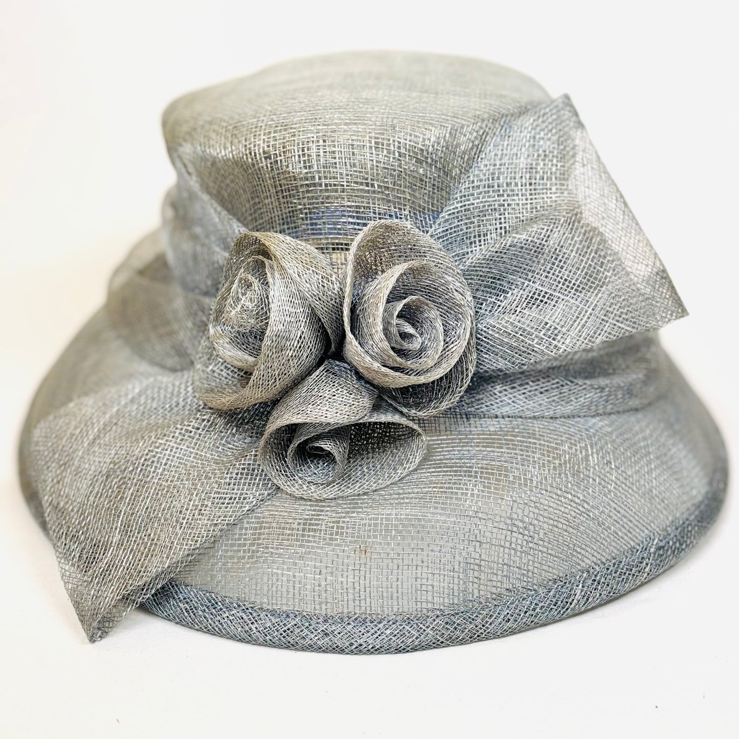 Light blue headpiece with structured rose detail.