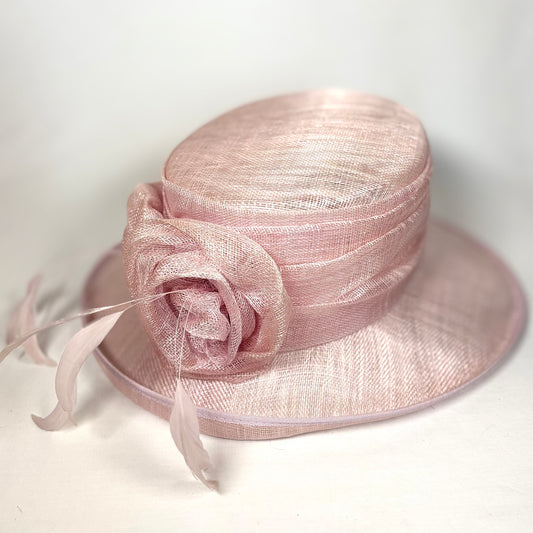 Pink occasion hat with feathered flower design
