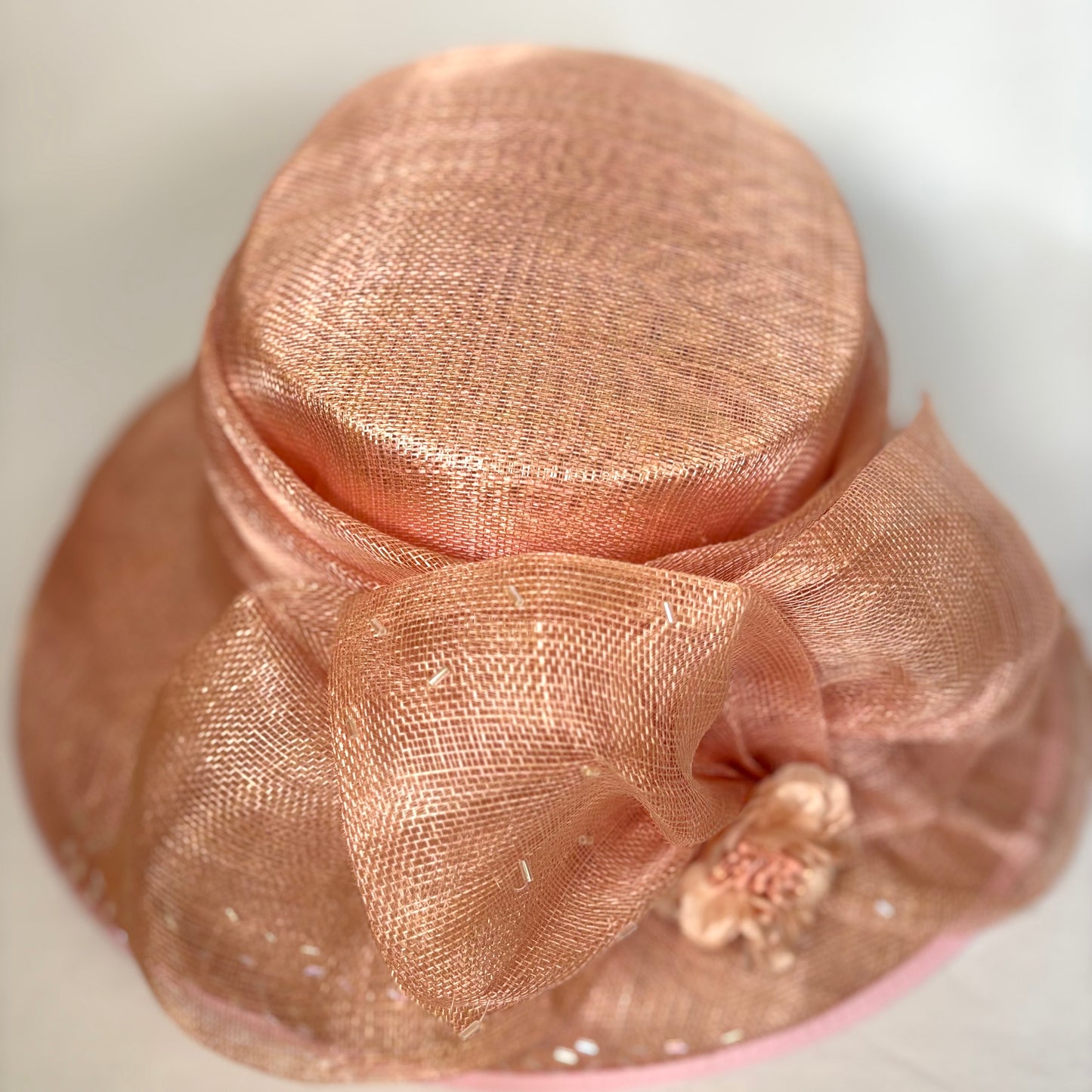 Orange statement occasion hat with bold flower design