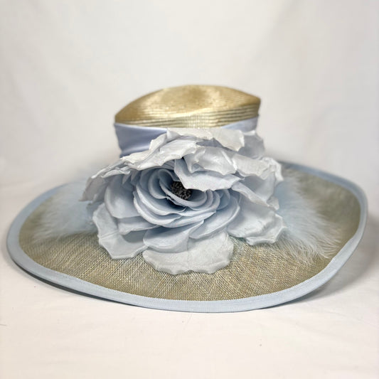 Wide-brim straw hat with pale blue feature flower design.