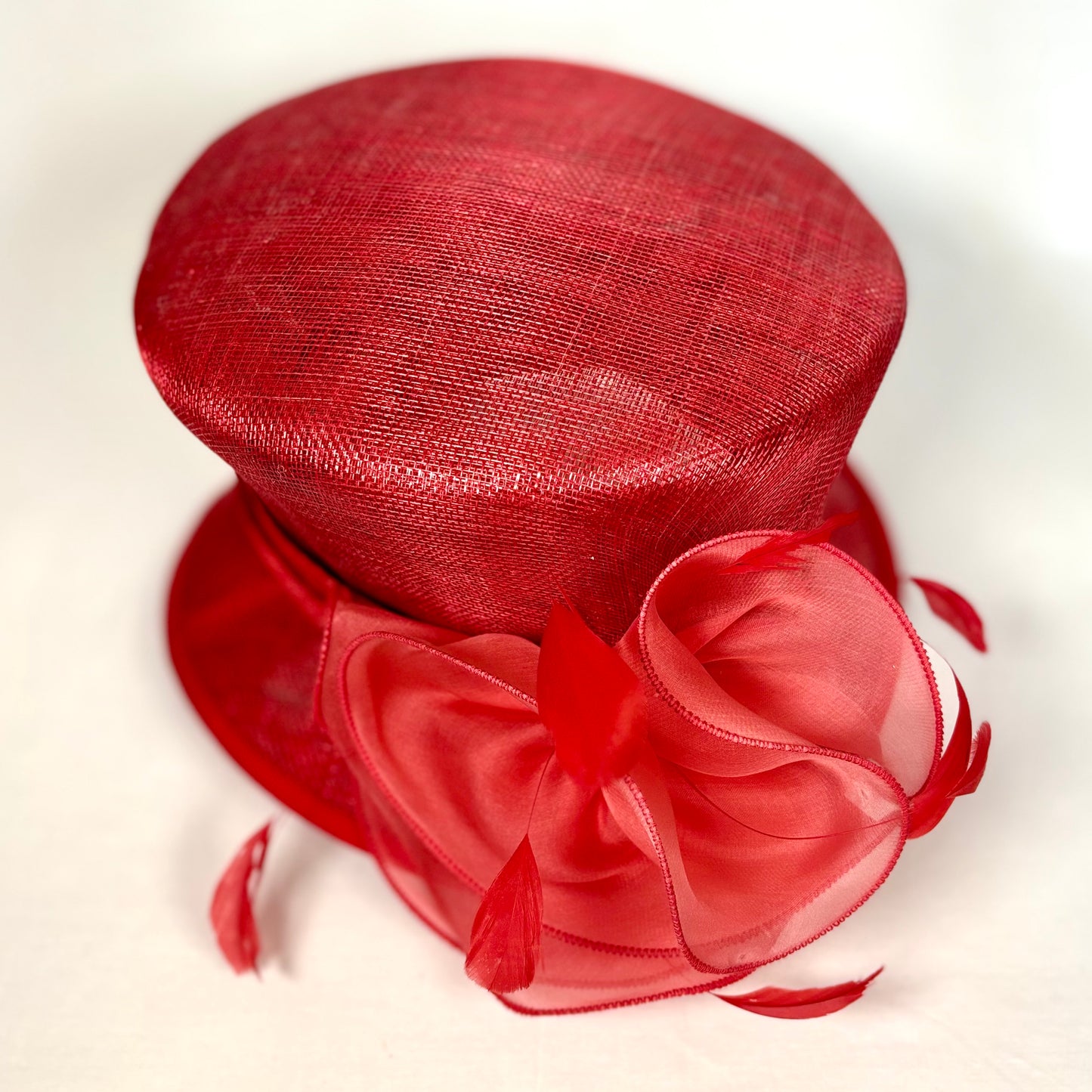 Red structured occasion hat with bold bow design