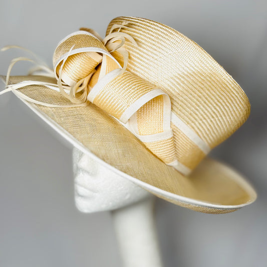 Cream straw occasion hat with light trim and statement bow design