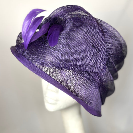 Purple occasion hat with soft feather detail