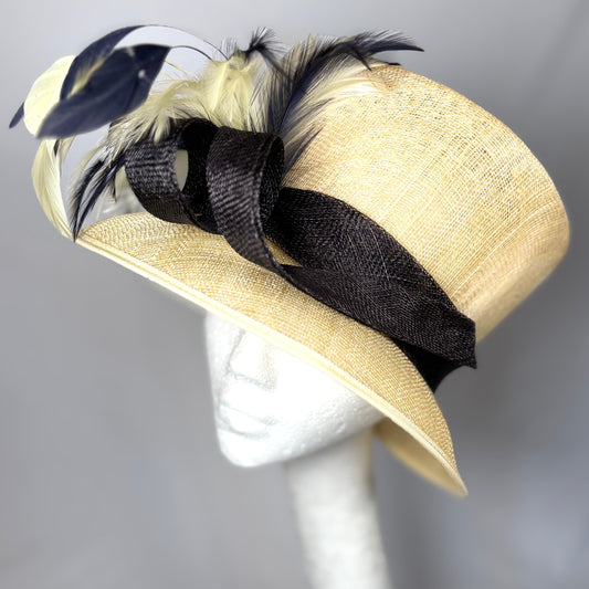 Cream and black classic style hat with statement feather detail