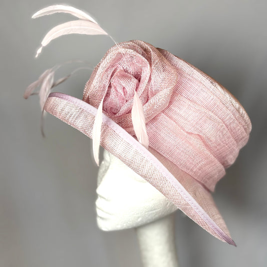 Pink occasion hat with feathered flower design