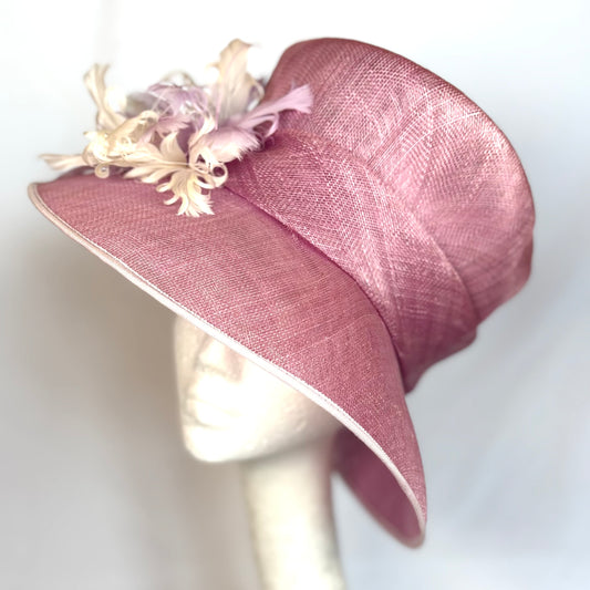 Pink structured occasion hat with feature flower design