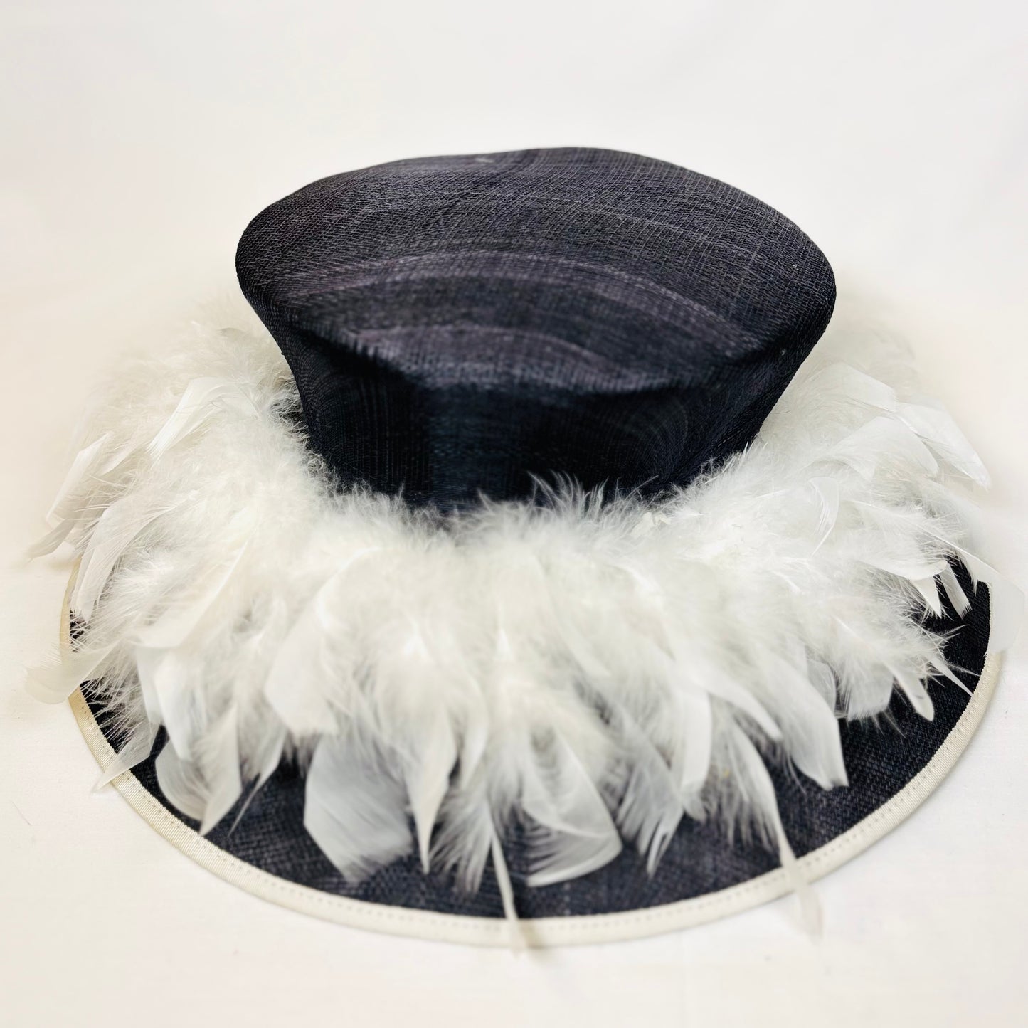 Navy occasion hat with feather design