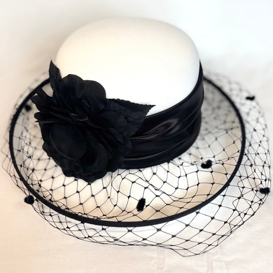White and black soft occasion hat with soft layered flower and net design