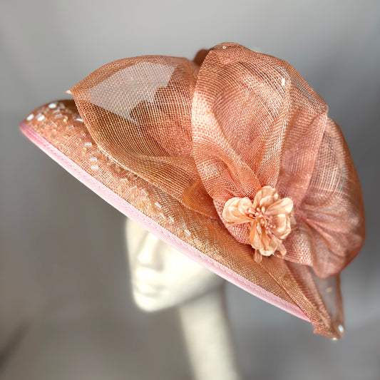 Orange statement occasion hat with bold flower design