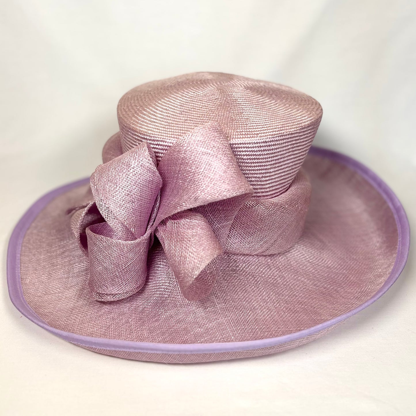 Purple occasion hate with wide turn up brim and sculpted flower design