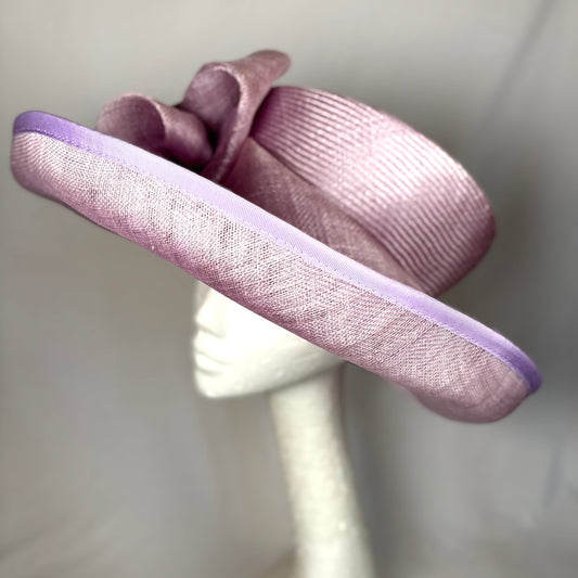 Purple occasion hate with wide turn up brim and sculpted flower design