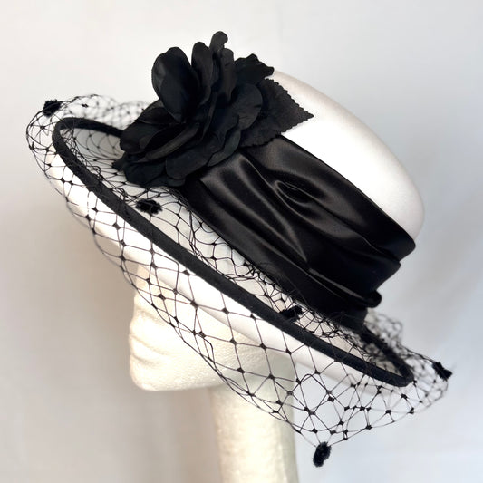 White and black soft occasion hat with soft layered flower and net design