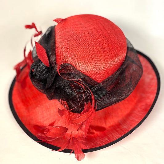 Red and black statement hat with bow and feather design
