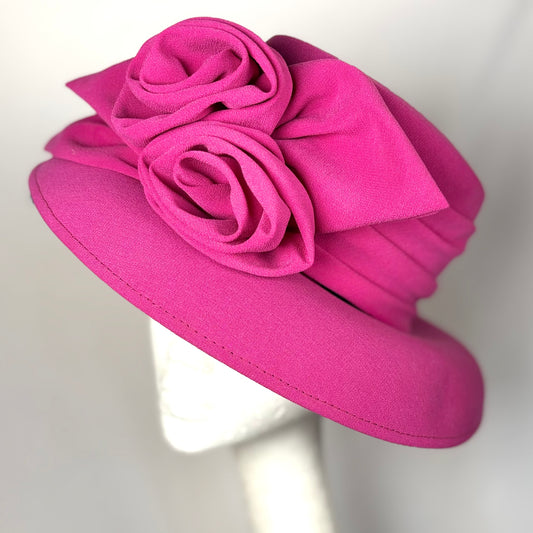 Pink occasion soft textured hat with bold flower design