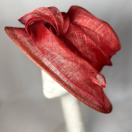 Warm orange occasion hat with structured bow design