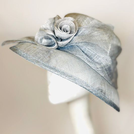 Light blue headpiece with structured rose detail.